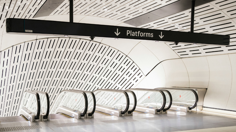 Modern subway station escalators leading to platforms, symbolizing the structured pathways of access rights. In the context of online platforms, such rights enable research but impose narrow constraints, raising questions about academic freedom.